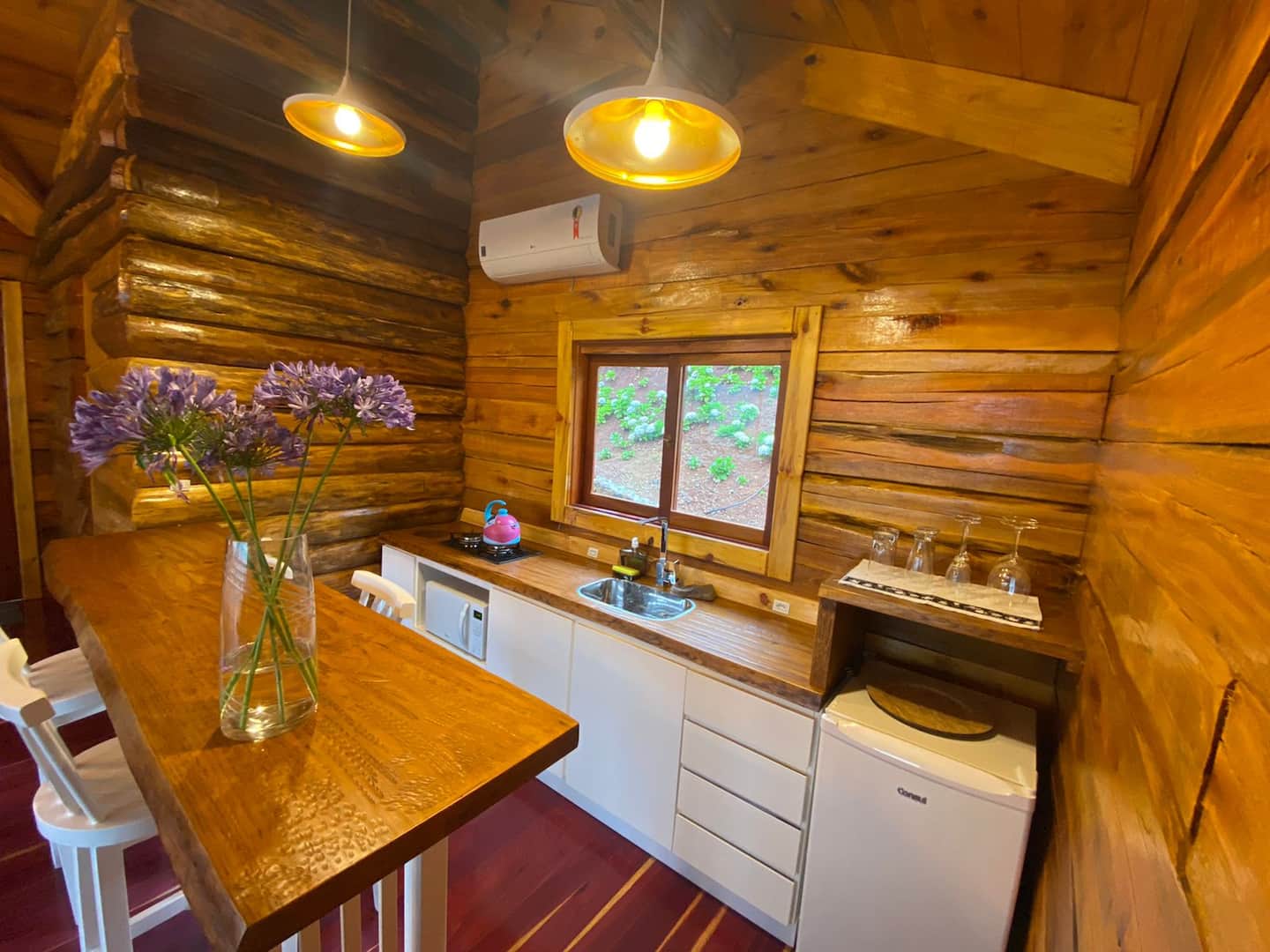 Cozinha de madeira com bancada e flores
